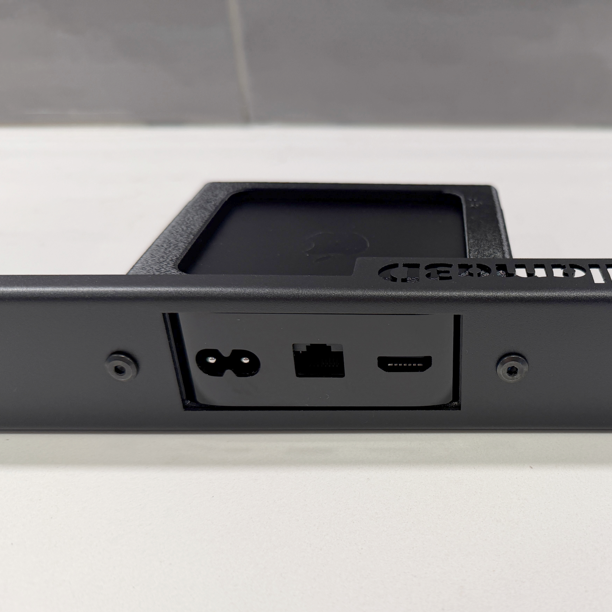 Apple TV mounted in reverse making ports accessible from the front of the rack